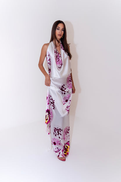 Studio portrait of a model wearing the Bunga luxury silk sarong styled as an elegant dress.